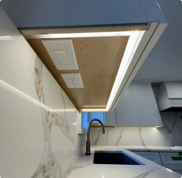 Under-cabinet lighting with outlets