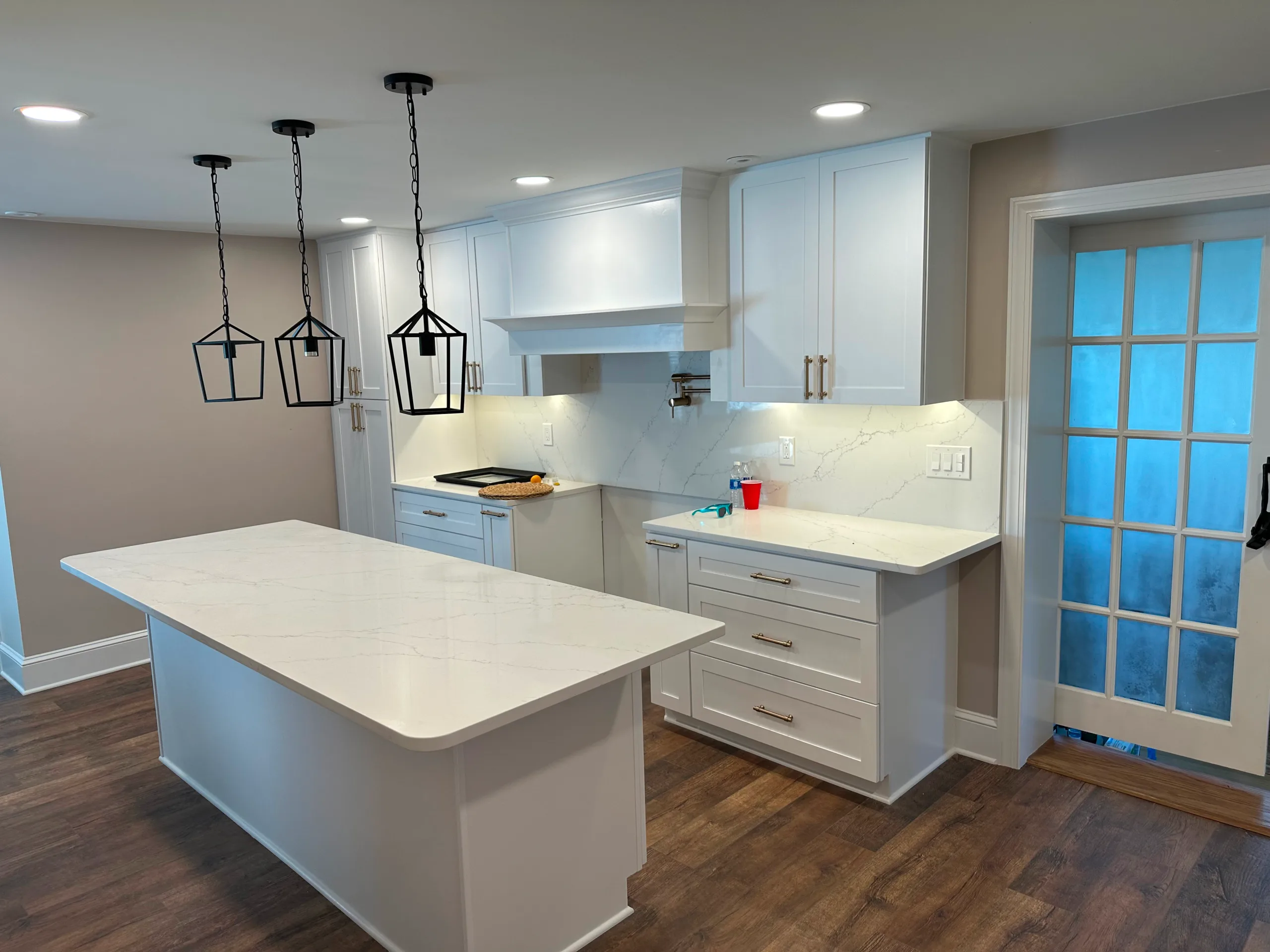Renovated kitchen with an island, pendant lights, and recessed lighting