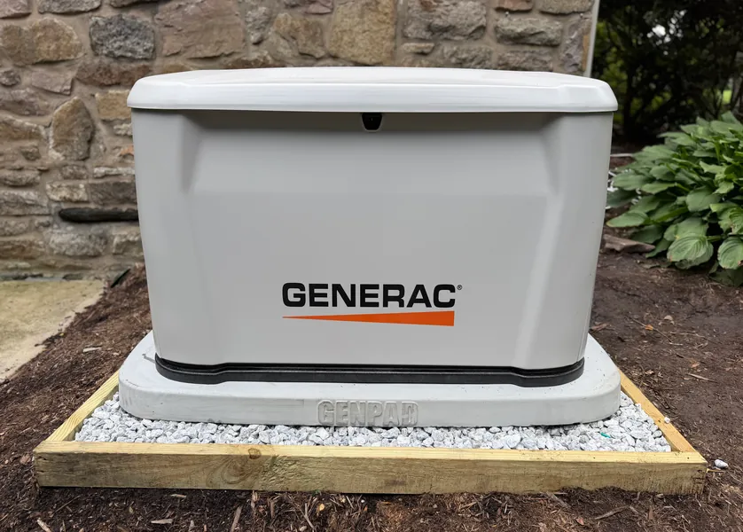 Standby generator installed next to a house