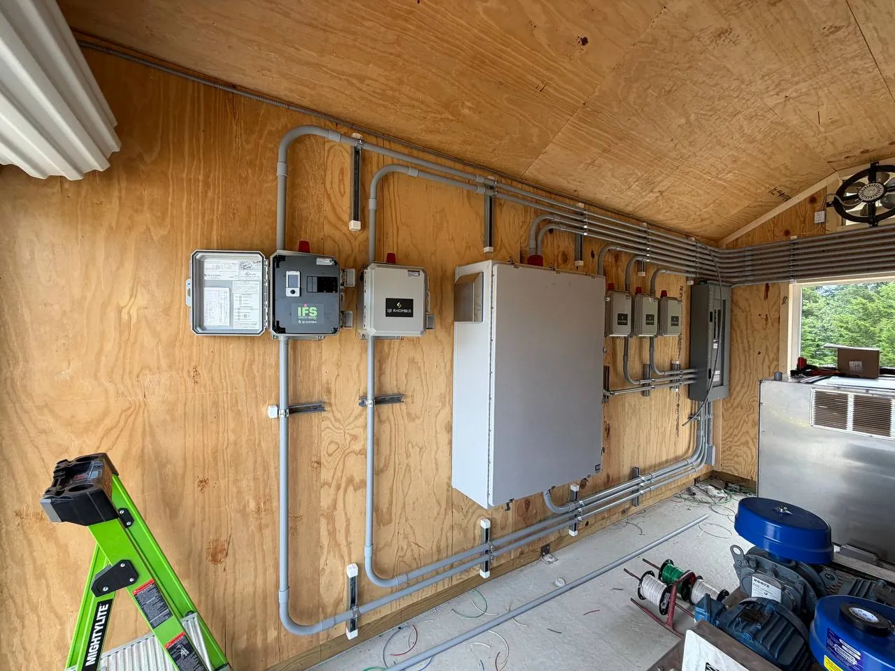 Equipment room with panels and conduit runs