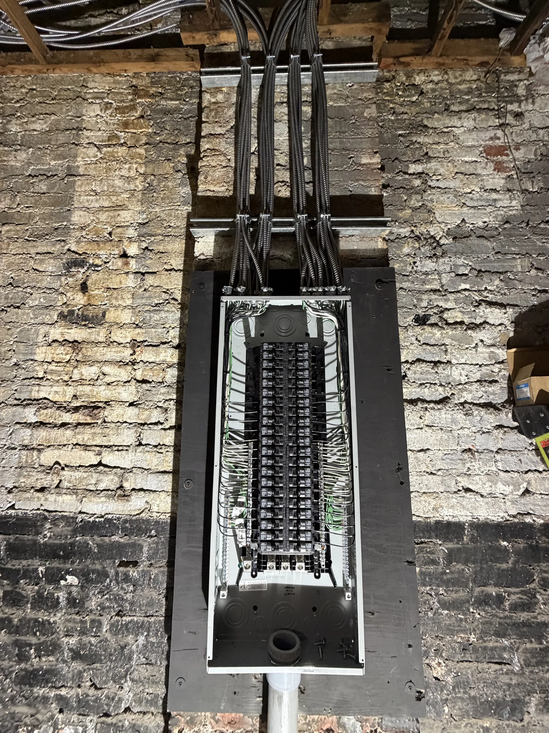 New panel with circuits on a brick wall