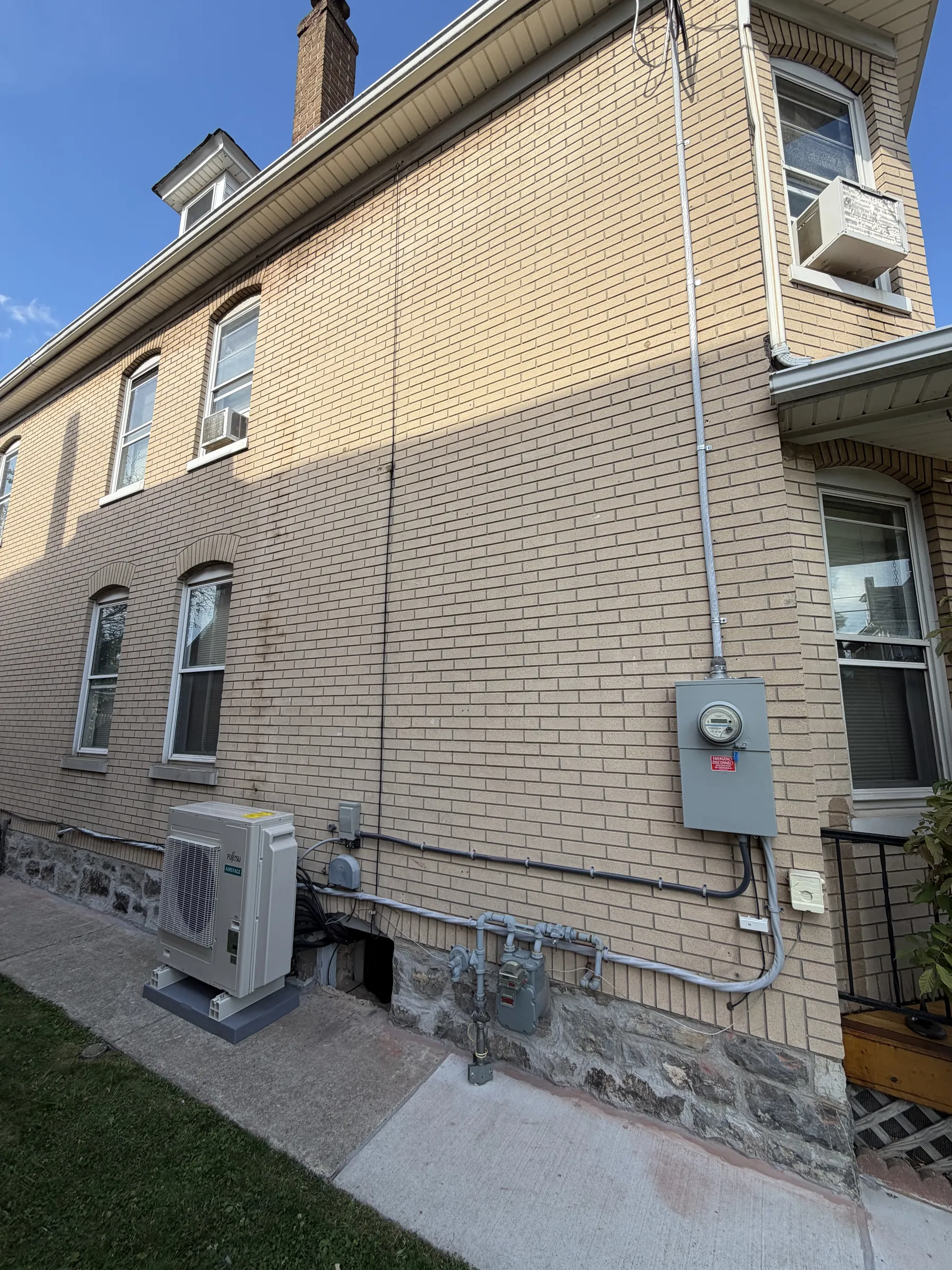 Meter and outdoor unit on a brick house
