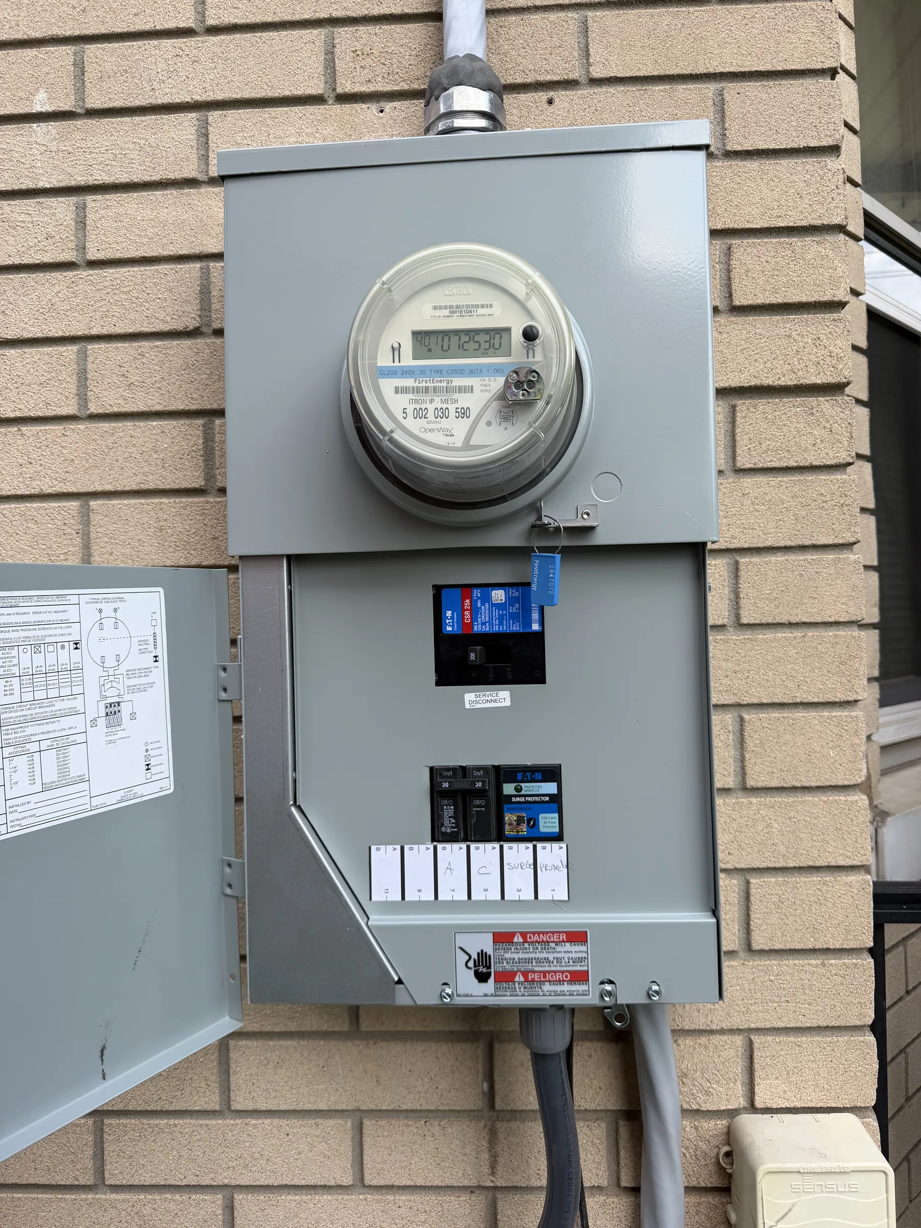 Meter and main disconnect on a brick home