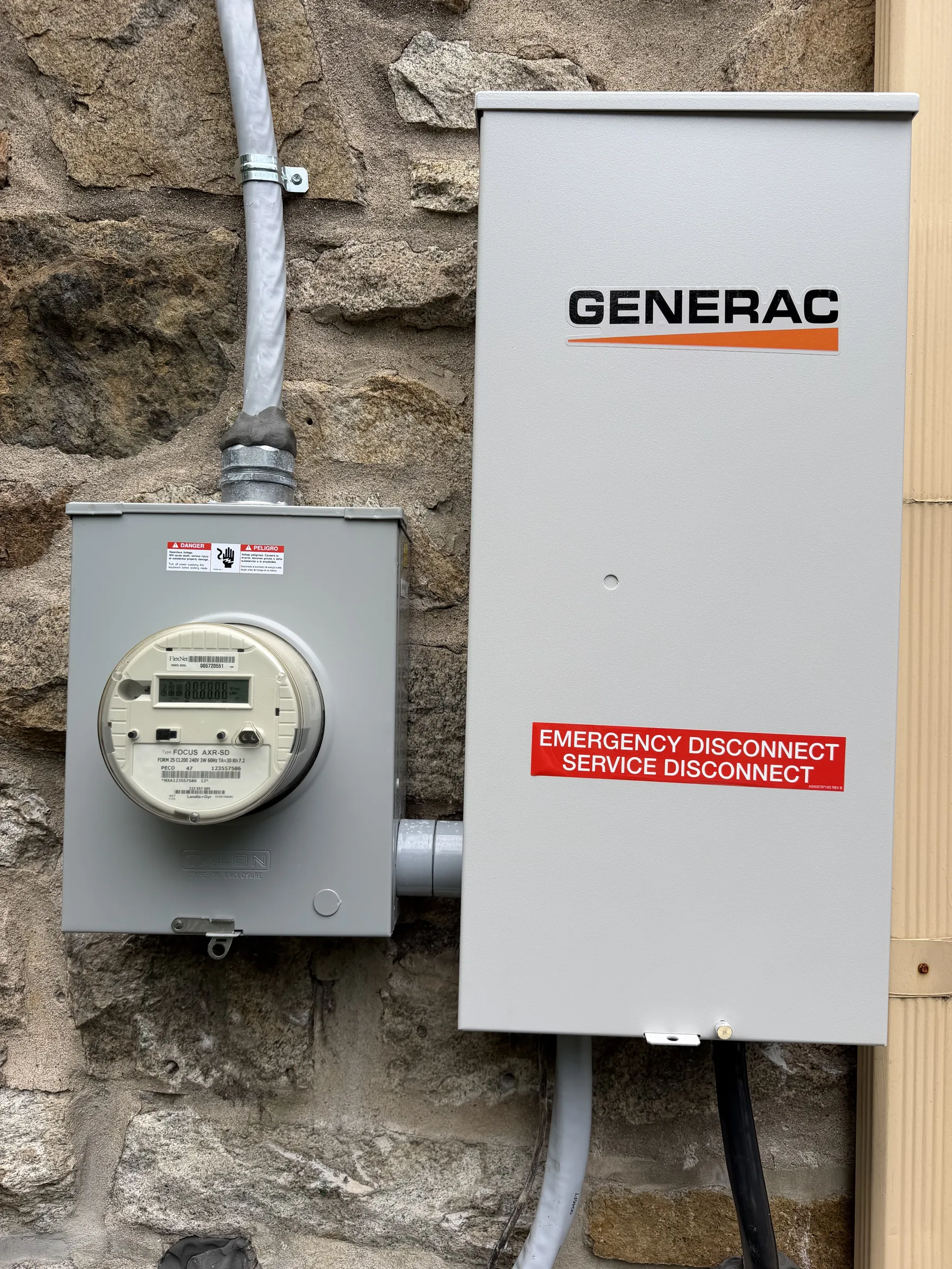 Meter and Generac transfer switch on a stone wall